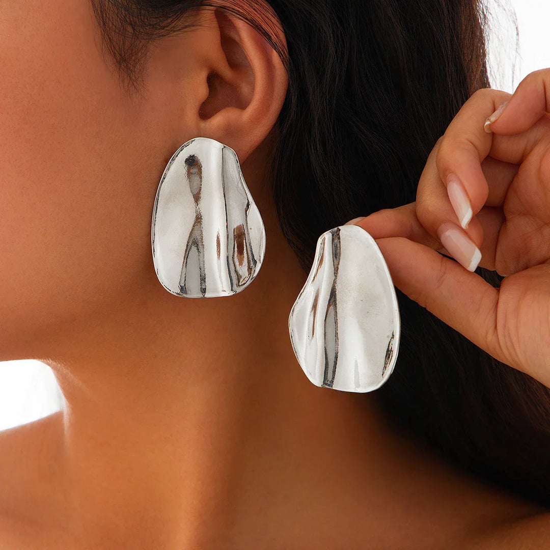 Abstract statement earrings with a sculpted metal design