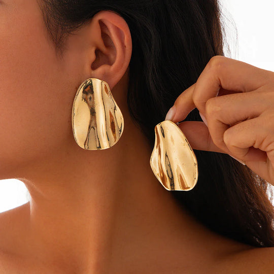 Abstract statement earrings with a sculpted metal design