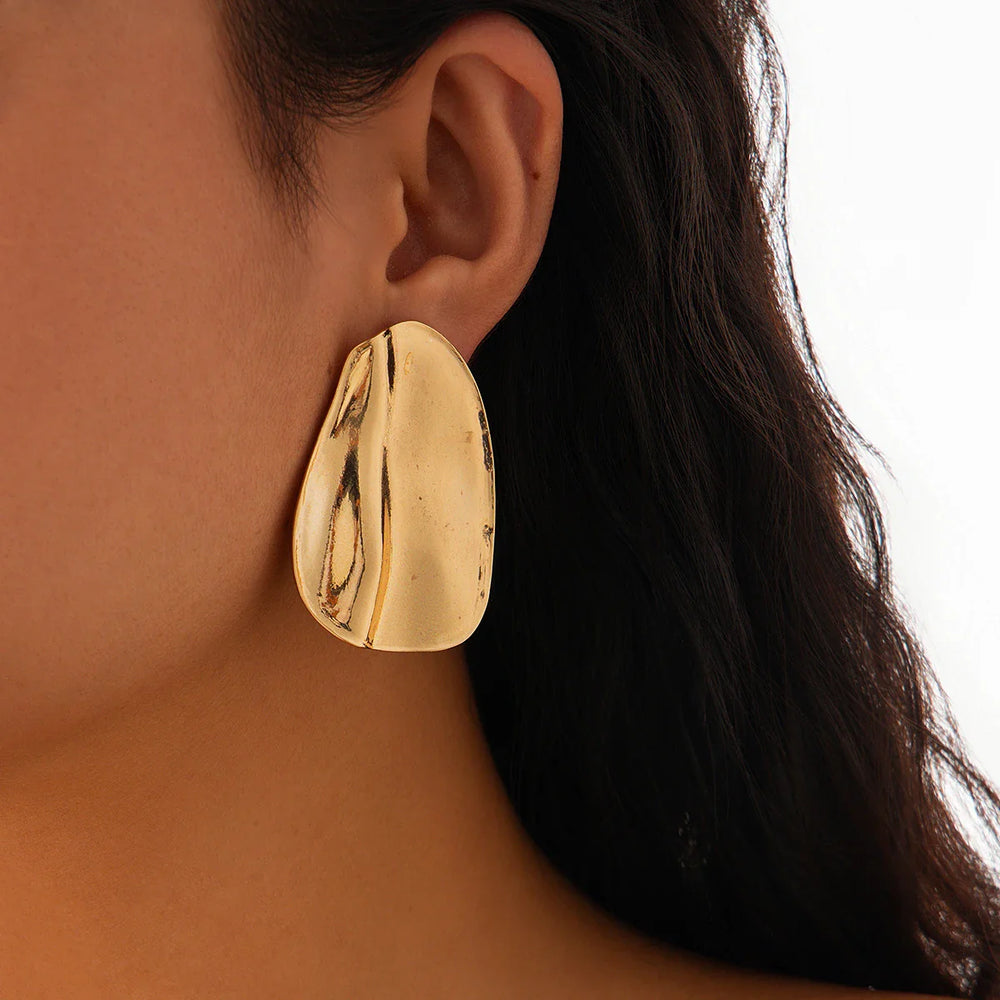 Abstract statement earrings with a sculpted metal design